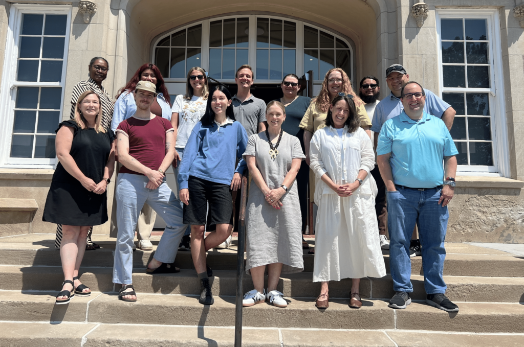 Team photo of Emspace team in July of 2024 outside of Yates Illuminates schoolhouse.